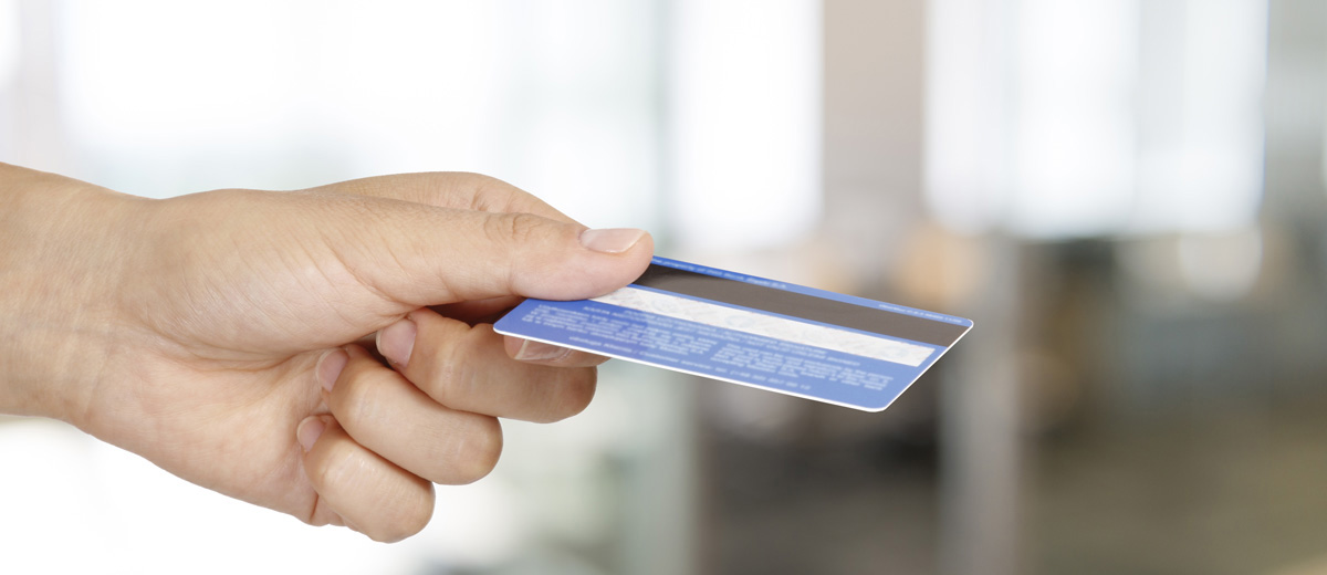 Photo of person holding credit card
